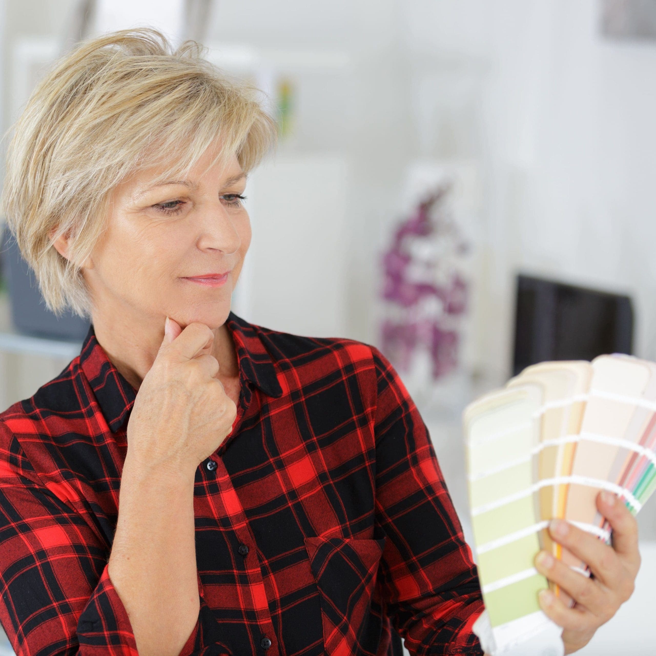 woman looking at paint chart in new kitchen