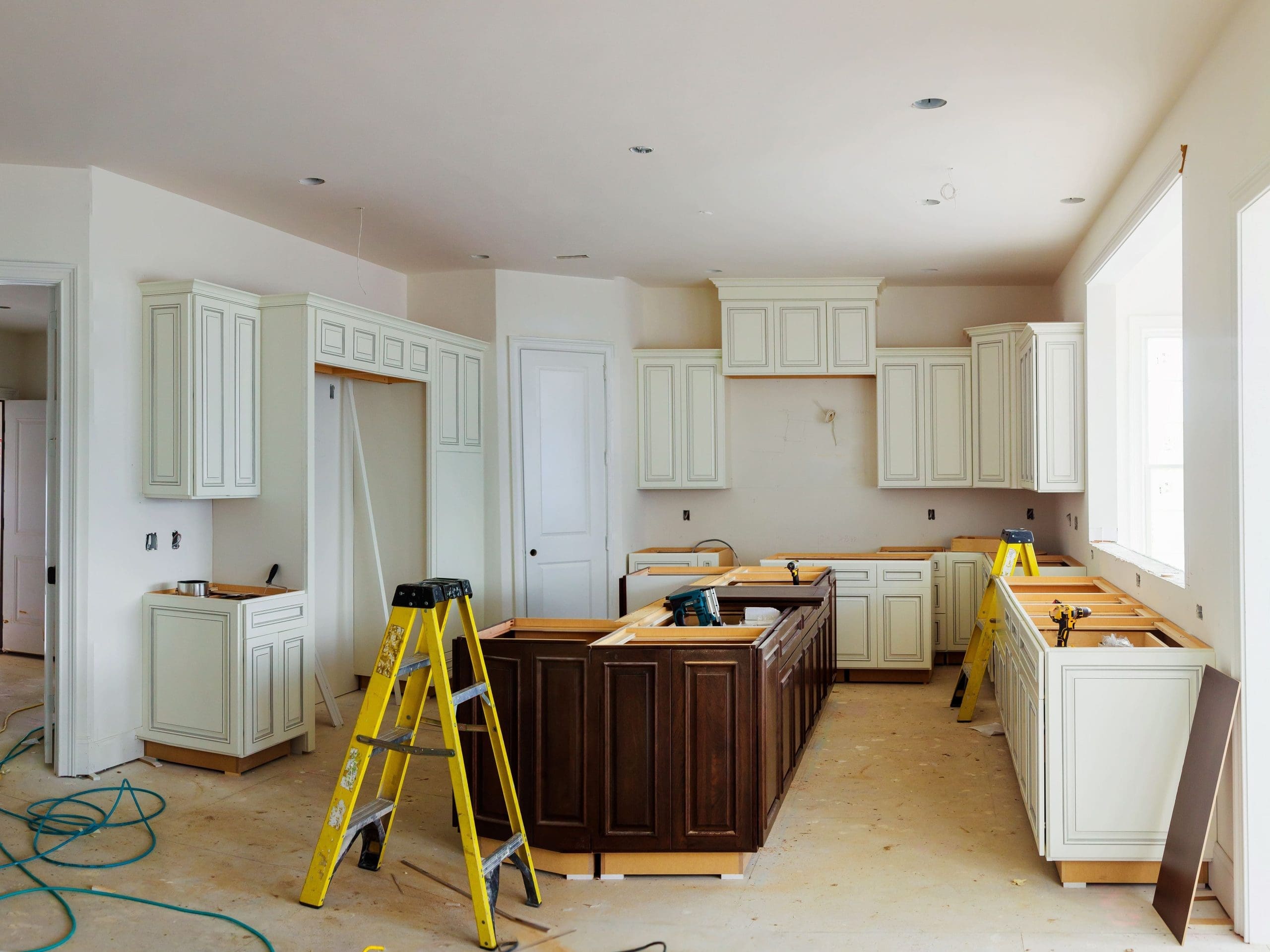 Installation of kitchen. Custom kitchen cabinets in various stages of installation base for island in center