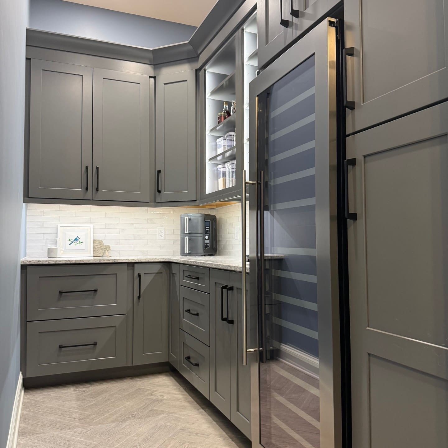 Custom, gray kitchen cabinets.